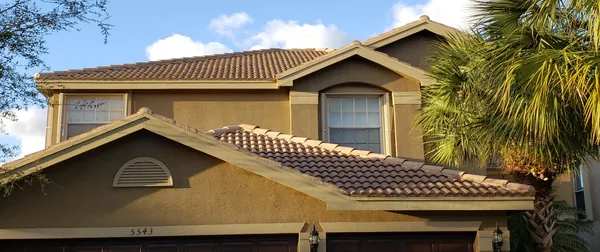 The same home after: clean roof and bright walls