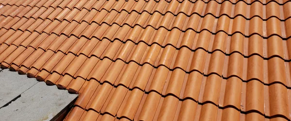 The same tile roof after: bright orange terracotta