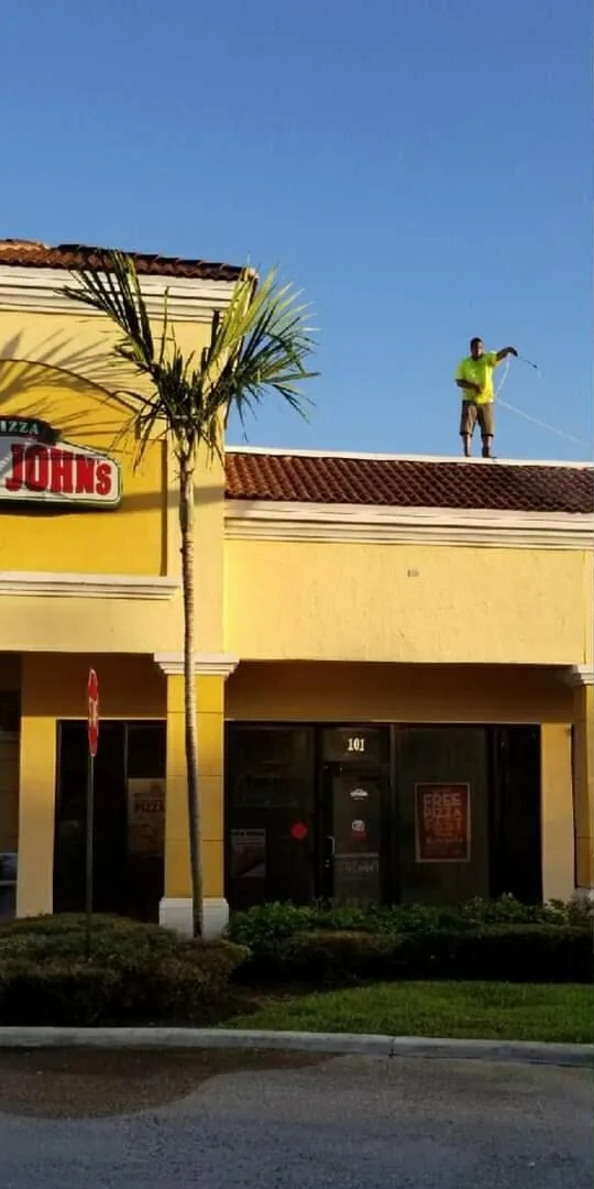 A Magic Touch crew member on a commercial rooftop