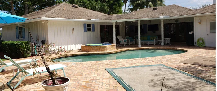 A paver pool deck and home after cleaning