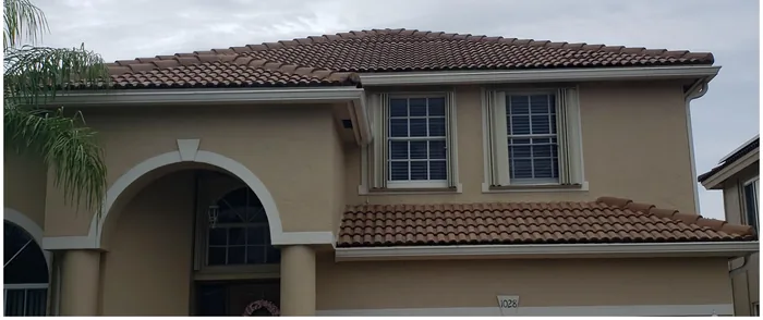 A two-story stucco home, freshly cleaned